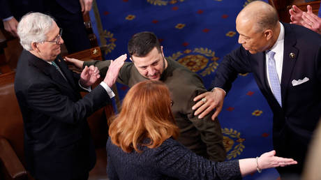 Senate Minority Leader Mitch McConnell (far left) pats Vladimir Zelensky on the shoulder as the Ukrainian president arrives to address a joint session of Congress on December 21 in Washington.