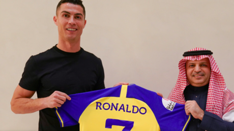 Cristiano Ronaldo holds up the Al Nassr shirt bearing his name after completing a deal to sign for the Saudi Arabian football team