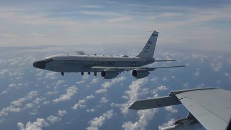 A US Air Force RC-135 aircraft flying close to  Chinese Navy J-11 fighter jet over the South China Sea.