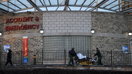 FILE PHOTO: Paramedics push a patient on a trolley outside the Accident and Emergency department at Bradford Royal Infirmary hospital in Bradford, Britain, January 5, 2022