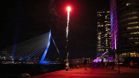 People set off fireworks near the Erasmus Bridge in Rotterdam on December 31, 2022.