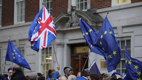 Pro-EU activists wave EU and Union Flags during a rally in London on January 31, 2020.