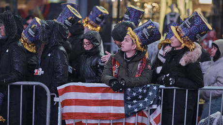 Revellers gather under the rain during the New Year's Eve celebrations in Times Square, New York, December 31, 2022