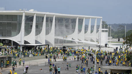 Supporters of Brazil's former President Jair Bolsonaro storm the Planalto Palace building in Brasilia, January 8, 2023