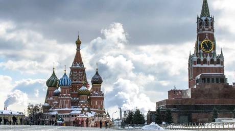 FILE PHOTO. People walk in front of St. Basil's Cathedral and the Kremlin on Red Square in Moscow on March 16, 2018.