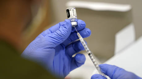 A healthcare worker fills a syringe with the Pfizer Covid-19 vaccine at Jackson Memorial Hospital in Miami, Florida, October 5, 2021