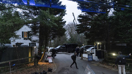 Members of the media stand along the access road to Joe Biden's home in Wilmington, Delaware, January 13, 2022