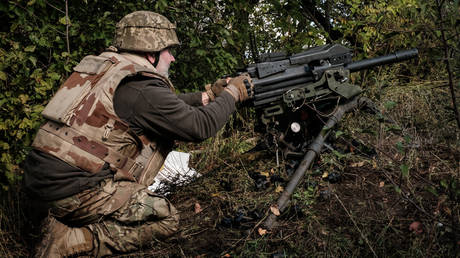 A Ukrainian soldier fires a US-made MK-19 automatic grenade launcher towards Russian positions on October 12, 2022.
