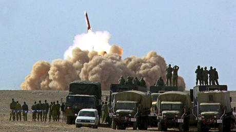 US and Israeli troops watch a Patriot missile launched during a joint drill from a base in the Negev Desert.