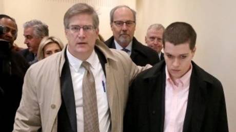 Jared “Riley” Dowell is led out of court by his lawyer on Monday in Boston.
