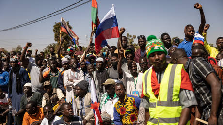 Protesters wave a Russian flag and demand the departure of French troops in in Ouagadougou, Burkina Faso, January 20, 2023.