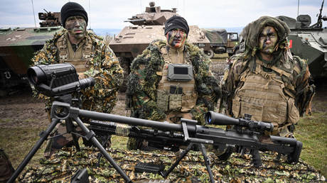 Soldiers from a special troop of the French army pose behind their equipment during a military exercise on November 25, 2022 in Cincu, Romania.