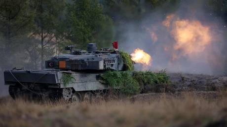 A Leopard 2 main battle tank of the German armed forces Bundeswehr fires its gun during drills.