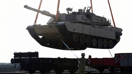 In this file photo taken on February 14, 2017, a US soldier helps to maneuver an Abrams tank from a railway car.