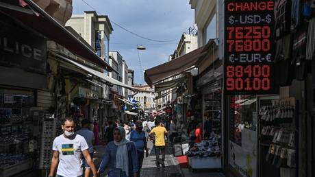 People walk past a currency exchange agency in Istanbul, Türkiye, September 24, 2020