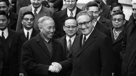 US National Security Advisor Henry Kissinger (R) shakes hand with Le Duc Tho, leader of North Vietnamese delegation, after the signing of a ceasefire agreement in Vietnam war, 23 January in Paris.