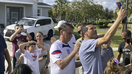 FILE PHOTO: Former Brazil President Jair Bolsonaro, center, meets with supporters outside a vacation home where he is staying near Orlando, Florida, January 4, 2023