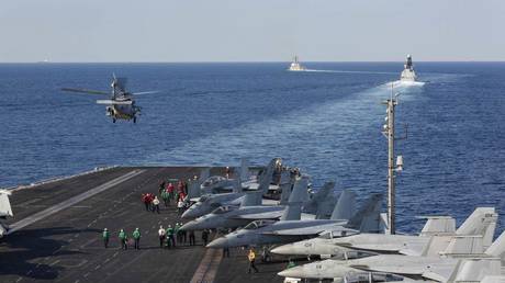 FILE PHOTO. The aircraft carrier USS Abraham Lincoln transits the Strait of Hormuz.