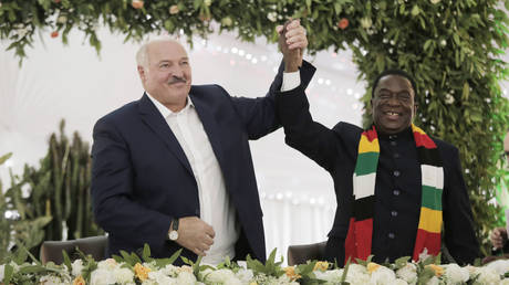 Belarus President Alexander Lukashenko poses with Zimbabwean President Emmerson Mnangagwa at the State House in Harare on January 31, 2023