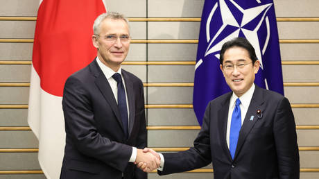 NATO Secretary General Jens Stoltenberg (left) shakes hands with Japanese Prime Minister Fumio Kishida on Tuesday in Tokyo.