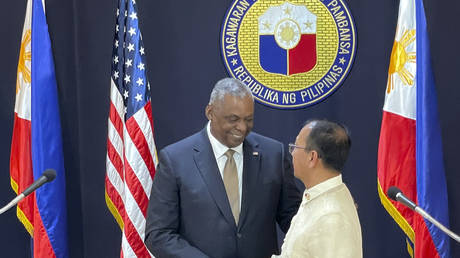 US Defense Secretary Lloyd Austin shakes hands with his Philippine counterpart, Carlito Galvez Jr. in Manila on February 2, 2023.