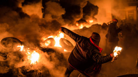 An anti-government protester throws a Molotov cocktail during clashes with police on Hrushevskoho Street near Dynamo stadium on January 25, 2014 in Kiev, Ukraine.