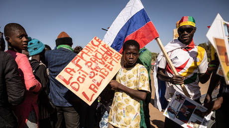 Protesters in Ouagadougou hold up a sign that reads "For liberty to come, France must go," calling for the withdrawal of French troops from Burkina Faso, January 20, 2023.