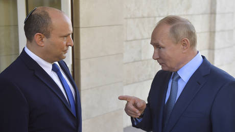 FILE PHOTO: Naftali Bennett and Vladimir Putin speak during a meeting in Sochi, Russia, October 22, 2021