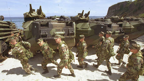 FILE PHOTO: US Marines gather April 27, 2002 near Amphibious Assault Vehicles before departing for a three-week joint military exercise dubbed Balikatan 02-2 at the US Marine Base in Ternate, Cabite province, 70 kilometers south of Manila, Philippines.