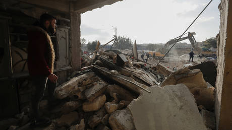 Rescue teams search through the wreckage of collapsed buildings in Aleppo, Syria, Tuesday, Feb. 7, 2023.