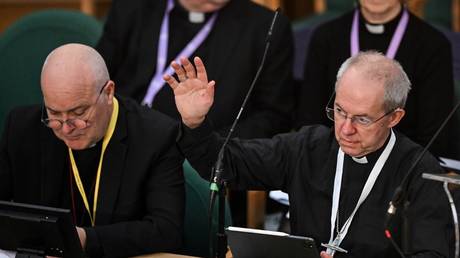Archbishop of Canterbury Justin Welby raises his arm during the Church of England Synod in London, Britain, February 7, 2023