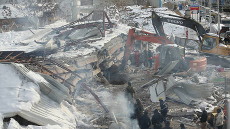 Rescuers look for survivors in the debris of a collapsed building in Malatya, Türkiye, February 8, 2023.