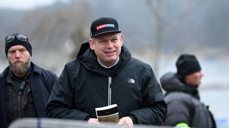 Rasmus Paludan holds a copy of the Koran outside the Turkish Embassy in Stockholm, Sweden, January 21, 2023