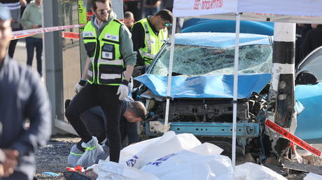 Emergency responders at the scene where two people were killed by a vehicle that struck a crowd at a bus stop near Jerusalem