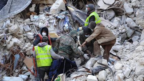 Rescue workers search for survivors among the rubble of a destroyed building in Aleppo, Syria, on Feb. 8, 2023.