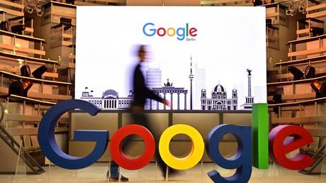 A technician walks past Google's logo during the opening day of the company's new office in Berlin, Germany, January 22, 2019