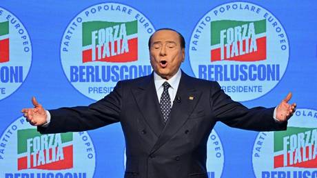Silvio Berlusconi acknowledges applause on stage during a meeting of his party in Milan, Italy, September 23, 2022