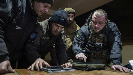 A Ukrainian commander of a unit aka Kurt (right) speaks to his comrades during planning morning operation at the frontline in Donetsk region, Ukraine, Monday, Feb. 13, 2023.
