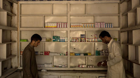 FILE PHOTO: Men restock a pharmacy in July 2017 in eastern Afghanistan.