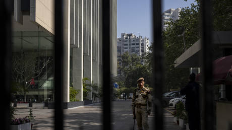 An armed security guard stands at the gate of a building housing BBC office in New Delhi, India, February 15, 2023