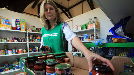 FILE PHOTO: Salisbury foodbank volunteer sorts a donation of food at the foodbank centre and cafe in Salisbury, England.