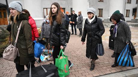 Residents of the Donetsk People's Republic are waiting for a bus near the House of Culture to evacuate to Russia.