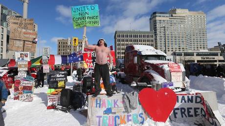 A protester makes his stand on Wellington Street as police begin to remove the "Freedom Convoy" in Ottawa from in front of Parliament Hill and surrounding streets after blockading the the downtown core of Canada's capitol for over three weeks. in Ottawa. February 18, 2022.