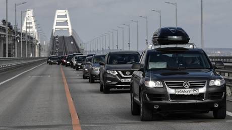 Cars drive on the Crimean Bridge, which is open to traffic on all lanes, in Kerch, Crimea, Russia.