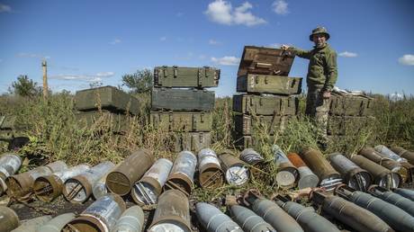 A Ukrainian soldier inspects an ammunition dump near the town of Izium, Ukraine, September 21, 2022