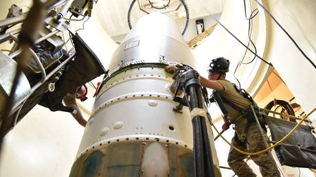 Technicians connect a re-entry system to a spacer on an ICBM in June 2020 at Malmstrom Air Force Base in Montana.