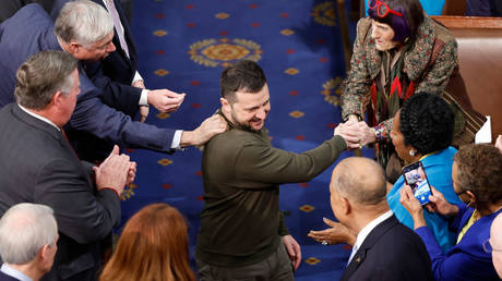 Ukrainian President Vladimir Zelensky is greeted by US lawmakers last December at the Capitol in Washington as he prepares to give a speech seeking more military aid.
