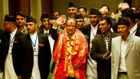 FILE PHOTO. Nepal's newly-elected Prime Minister Pushpa Kamal Dahal, known as Prachanda, (C), greets supporters as he leaves the Parliament Building in Kathmandu on August 3, 2016.