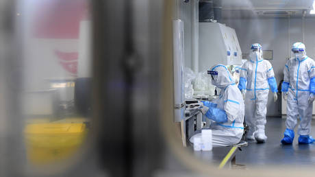 People in PPE work in the Huo-Yan Laboratory designed for high-capacity 2019-nCoV (SARS-CoV-2) detection in Wuhan in central China on Thursday, Aug. 05, 2021