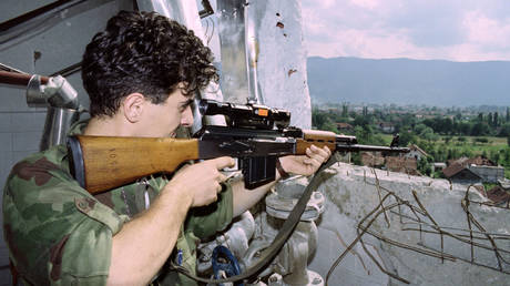A Bosnian fighter aims his sites on a Serbian position in the Dobrinja district, one of the most dangerous sites on the frontline in the Bosnian capital Sarajevo, on July 12, 1992.